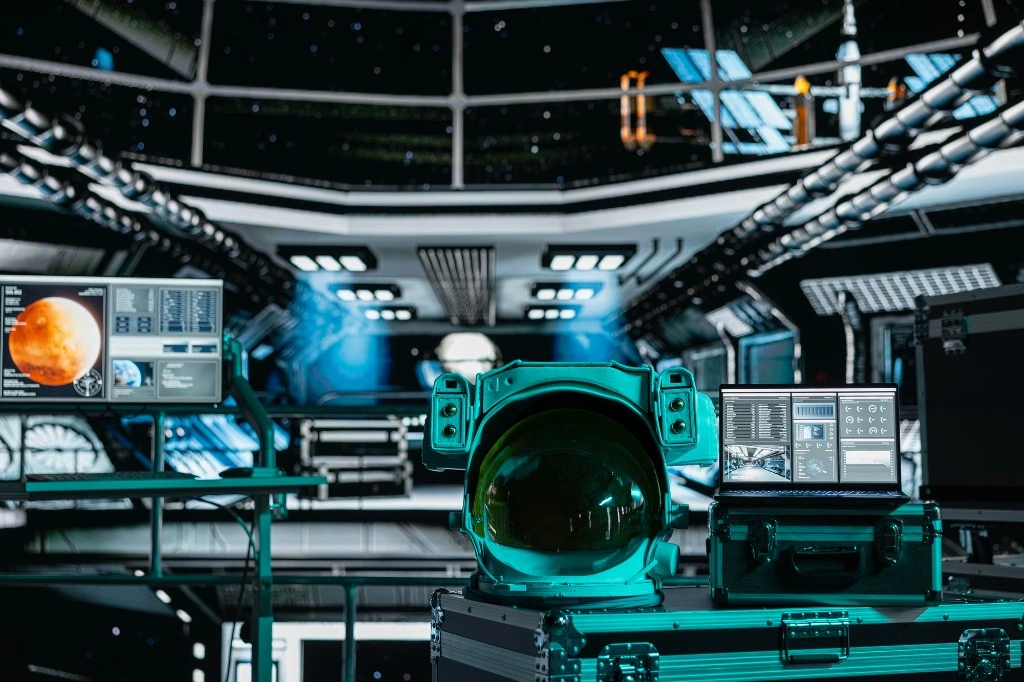 A hardware engineer in a yellow safety jacket using a laptop to troubleshoot server rack components and verify Hardware logic design integration on-site.