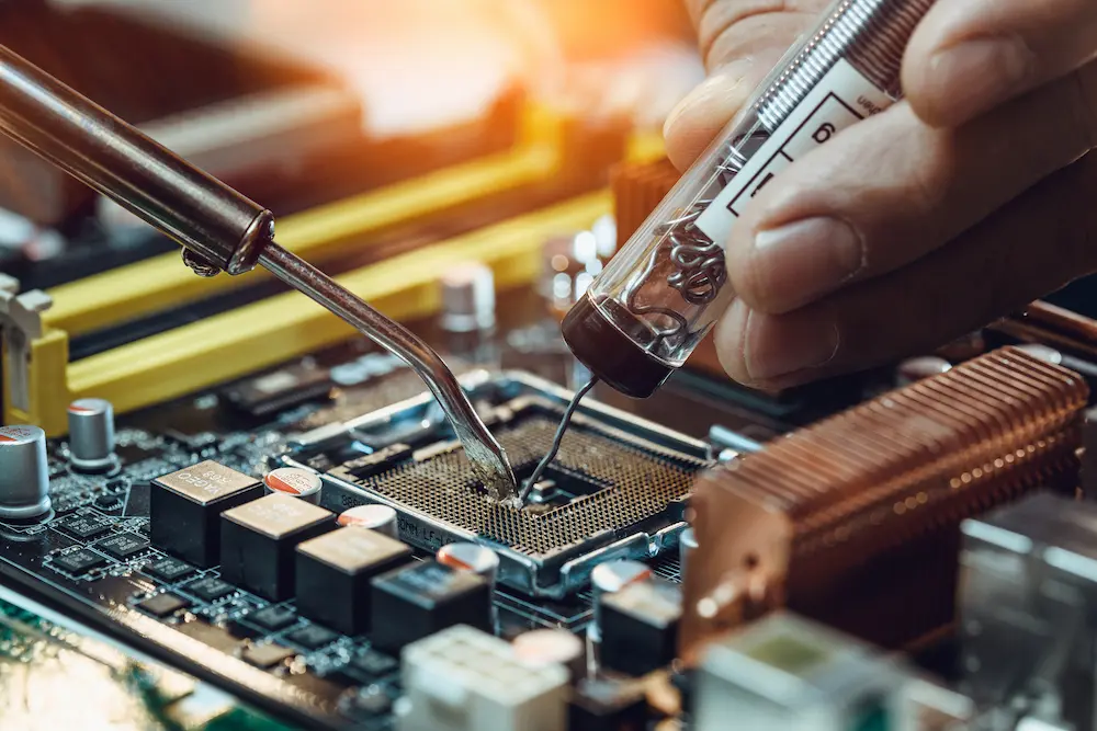 Expert precision soldering on a motherboard, highlighting the work of an RF Design Consultant.